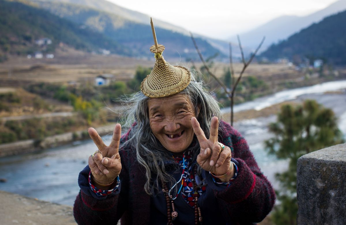 A Bhutanese elder smiling in traditional dress