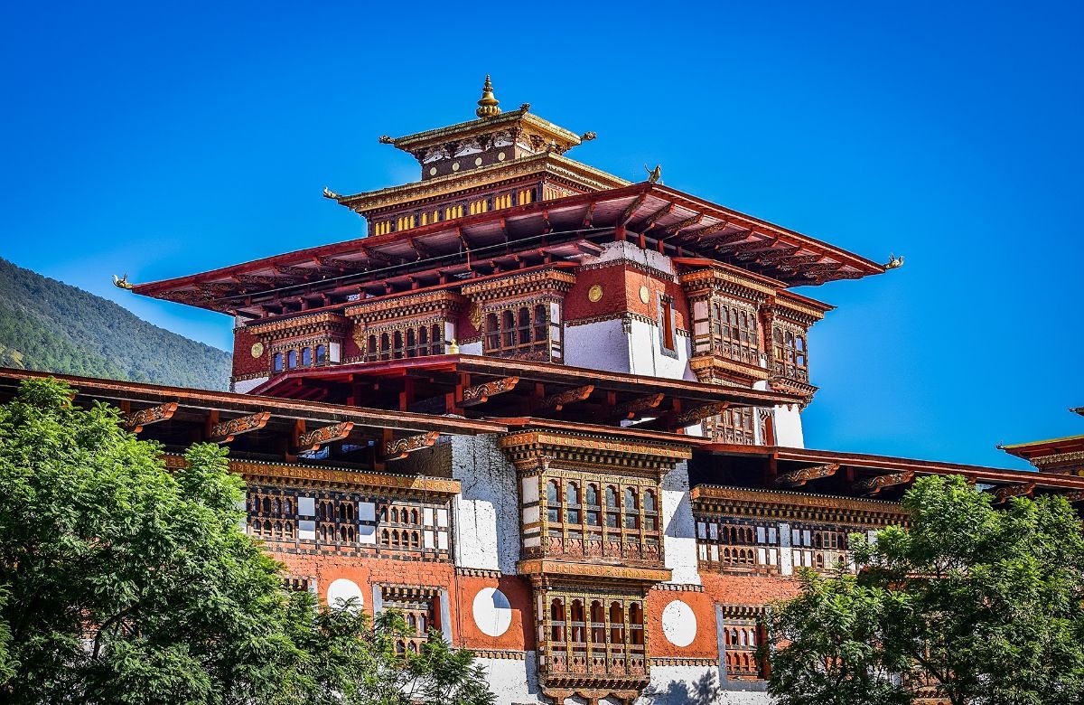 Traditional Bhutanese architecture with carved windows and a golden roof