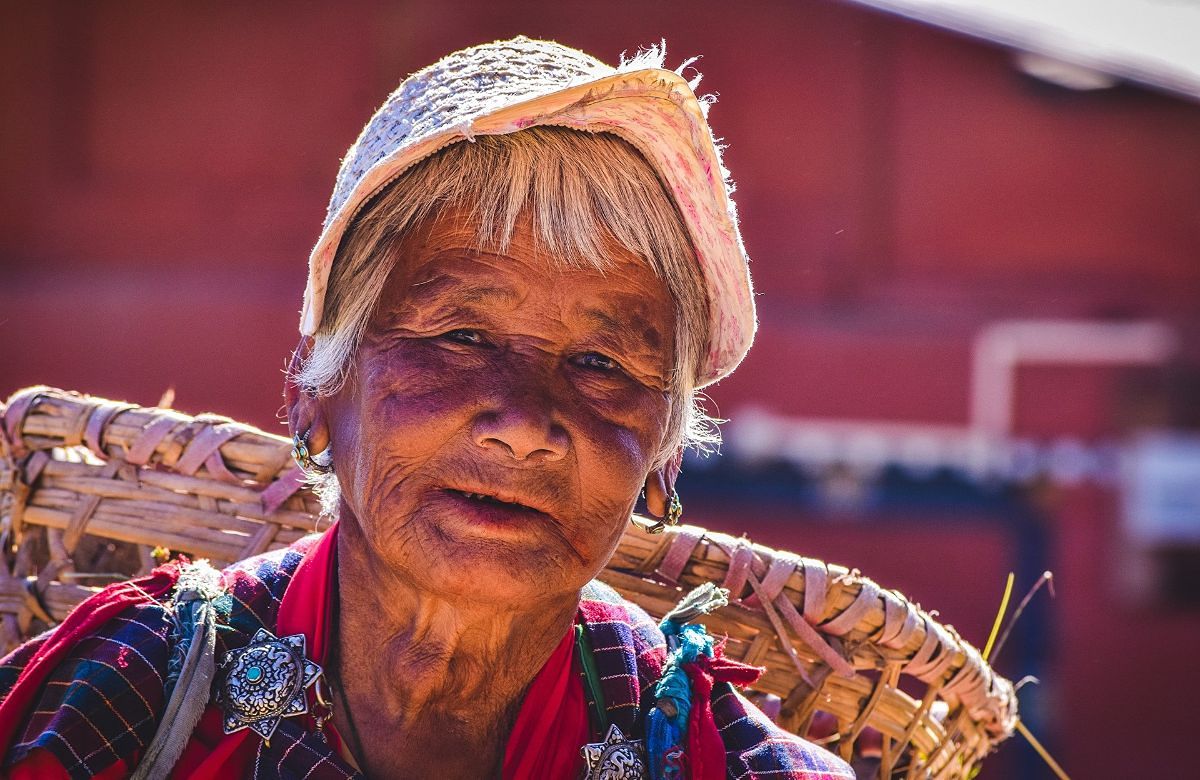 A Bhutanese woman carrying a traditional bamboo basket