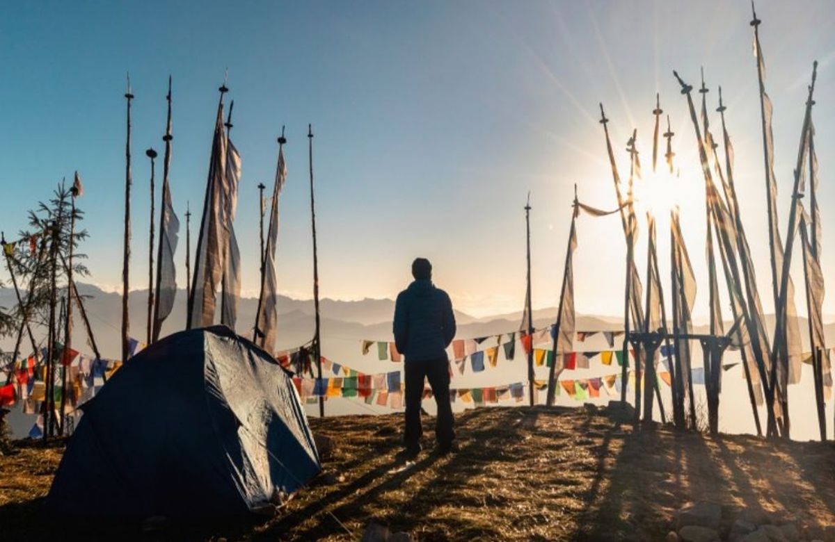 Prayer flag poles on a ridge at sunrise in Bhutan