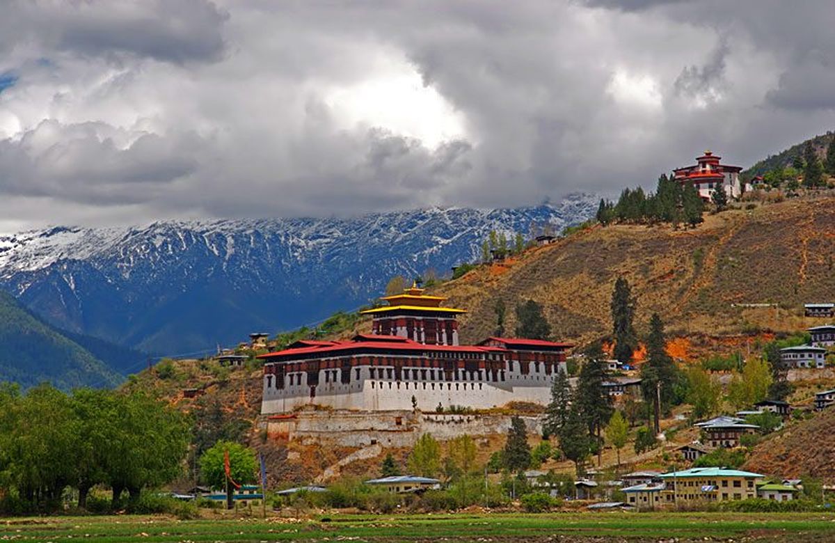 Rinpung Dzong above the Paro Chhu with snow peaks behind