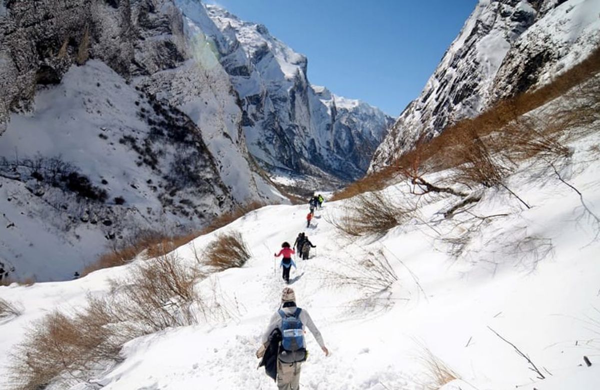 Trekkers crossing a high snow pass in Bhutan