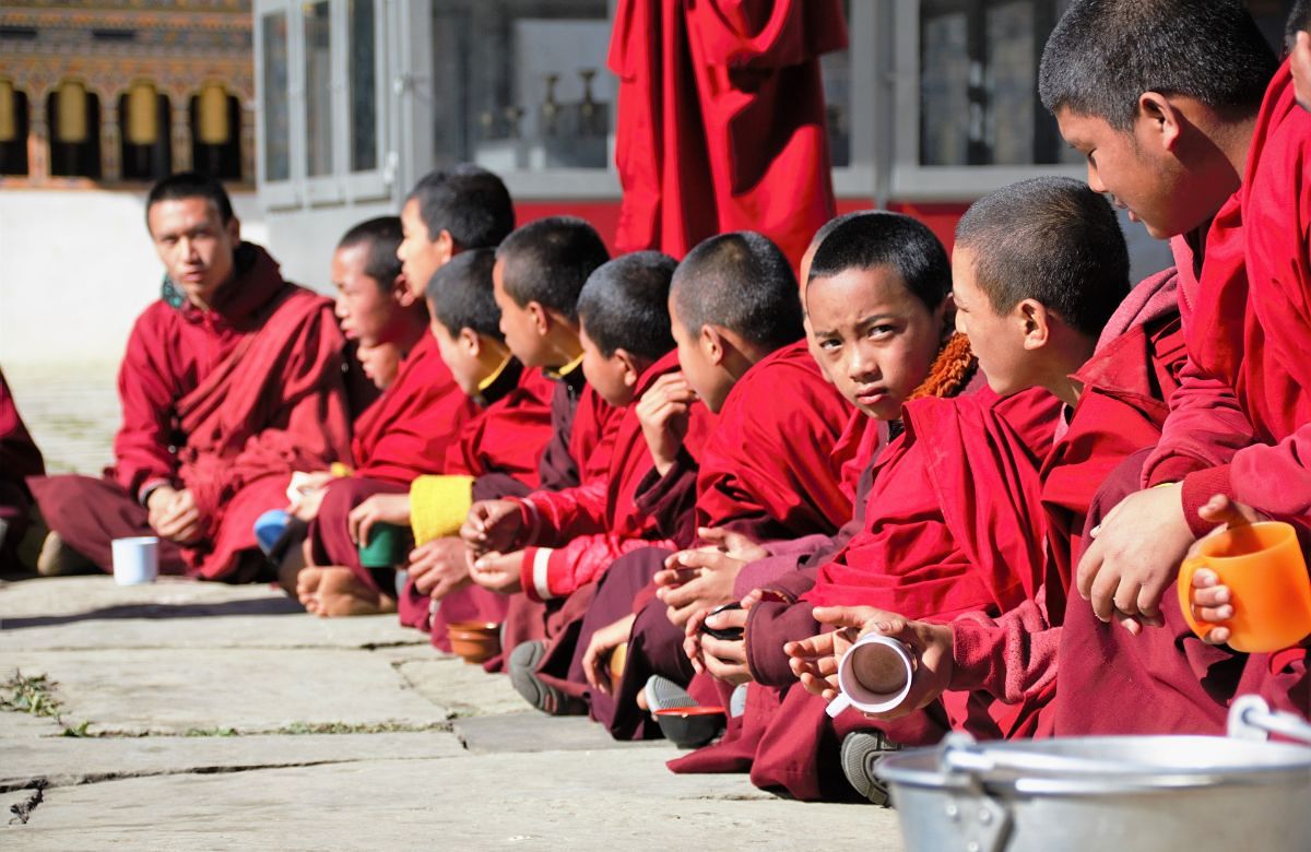 Young monks at a monastery meal in Bhutan